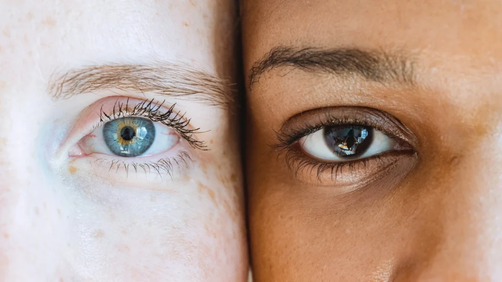 Two human beings, white and black, face to face, practicing self-acceptance